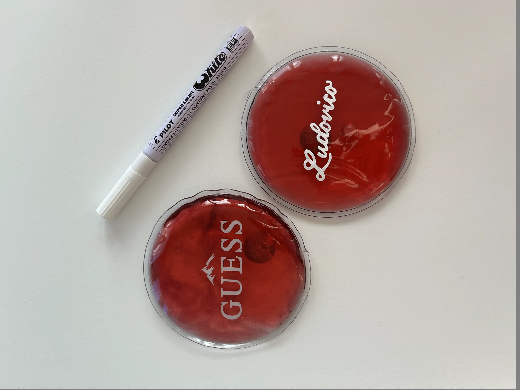 Two red GUESS pieces hand-lettered with names